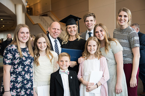 BYU-Idaho Winter Semester Graduation. A graduate poses with her family. Apr 2018