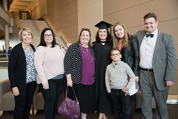BYU-Idaho Winter Semester Graduation. A graduate poses with her family. Apr 2018