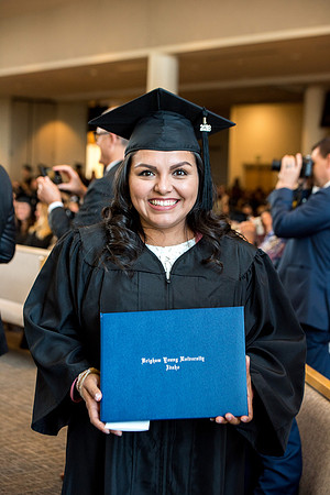 BYU-Idaho students graduate from College of Eduation and Human Development convocation receive their diplomas.