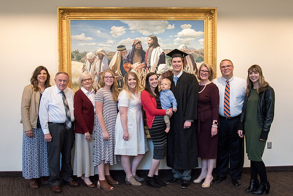 BYU-Idaho graduates with their family on campus.