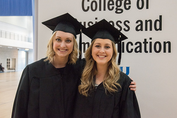 BYU-Idaho graduates with their family on campus.