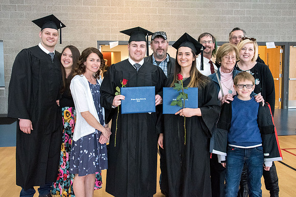 BYU-Idaho graduates with their family on campus.