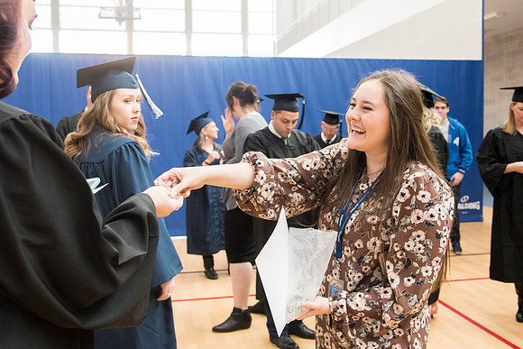 Graduates meet in the I-Center Courts for Processional.
