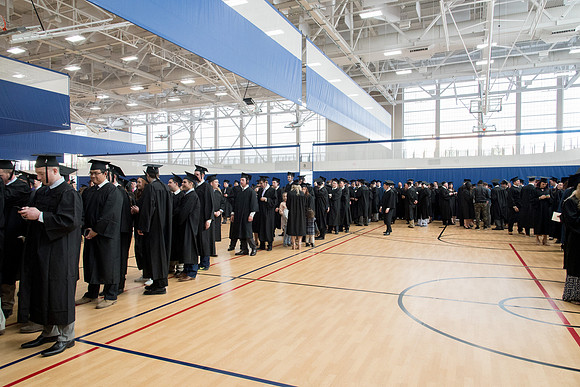 Graduates meet in the I-Center Courts for Processional.