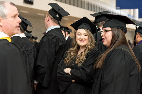 Graduates meet in the I-Center Courts for Processional.