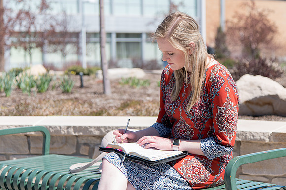 Carlie Webster, sophomore, reading her scripture on campus.