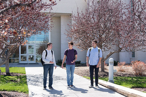 Students walking out from Taylor building after a class.