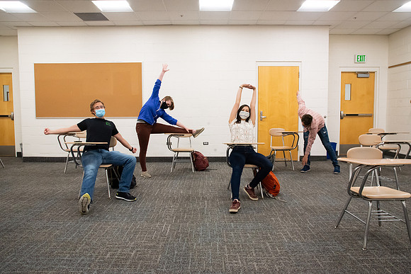 Examples of students staying safe and healthy during the COVID-19 pandemic by social distancing, following pathway arrows, and wearing face masks.