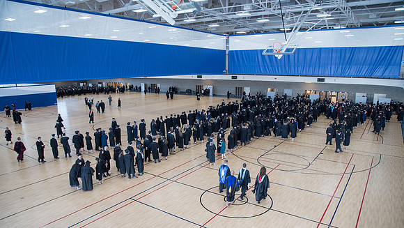 Graduates meet in the I-Center Courts for Processional before Commencement begins. April 2018
