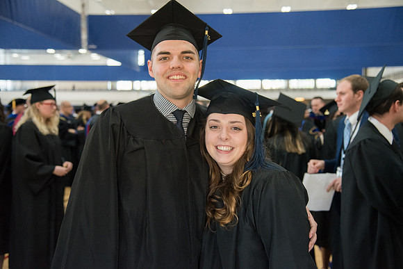 Graduates, Allison and Calvin Fuhriman meet in the I-Center Courts for Processional before Commencement begins. April 2018