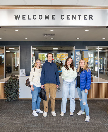 Employee giving a tour around campus to prospective students and their parents.