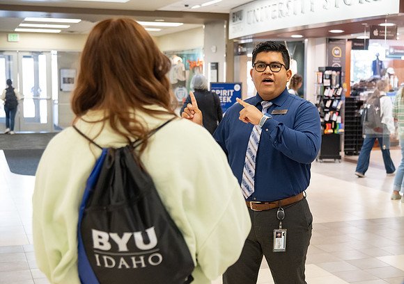 Employee giving a tour around campus to prospective students and their parents.
