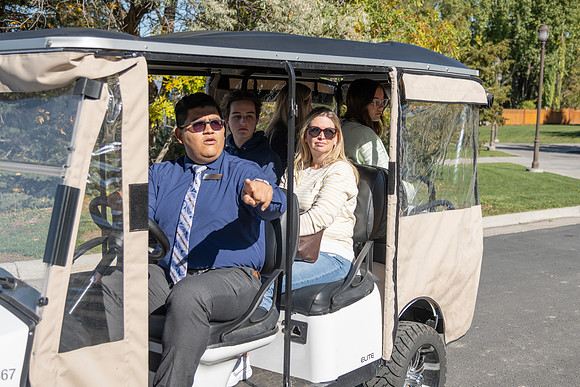 Employee giving a tour around campus to prospective students and their parents.