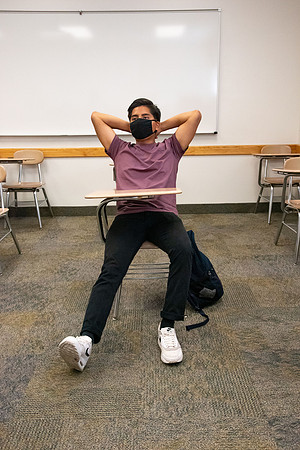Examples of students staying safe and healthy during the COVID-19 pandemic by social distancing, following pathway arrows, and wearing face masks.