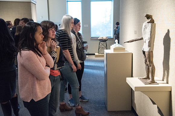 Students admire the sculptures at the Opening Gallery Reception for the Body and Meaning Exhibit. Sculptures done by Brian Christensen and Bryon Draper in the Jacob Spori Gallery. May 2018