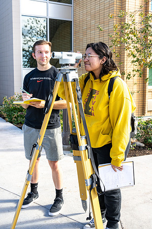 Students practicing surveying for Civil Engineering class.
