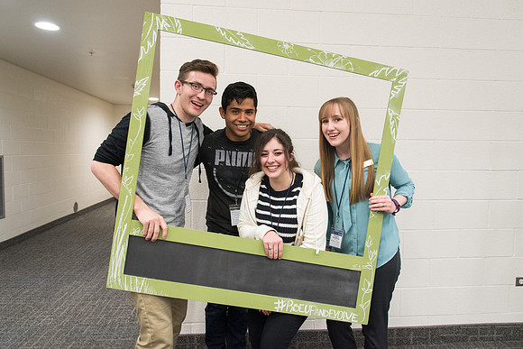 Student employee mingling before the conference.