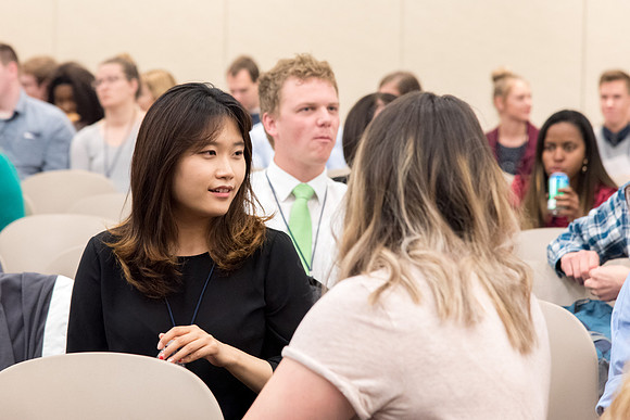 Student employee mingling before the conference.