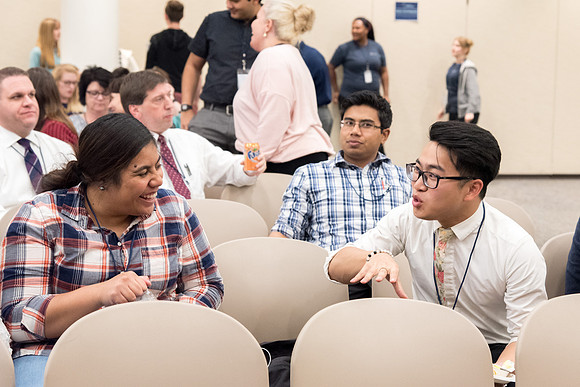 Student employee mingling before the conference.