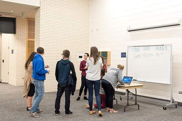 Student employee mingling before the conference.