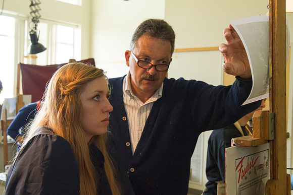Brother Vince Bodily points out to one of his students, the things that need to be included in her painting.