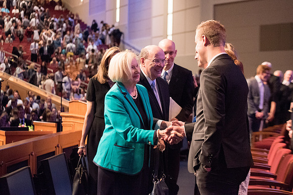 Elder Quentin L. Cook, Quorum of the Twelve Apostles, interacts with people after the Devotional.