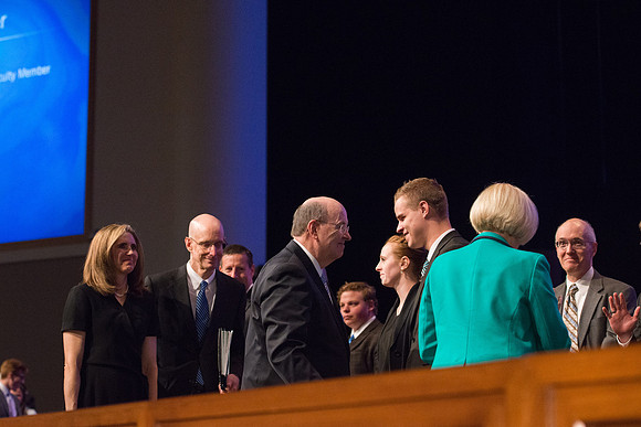 Elder Quentin L. Cook, Quorum of the Twelve Apostles, interacts with people after the Devotional.