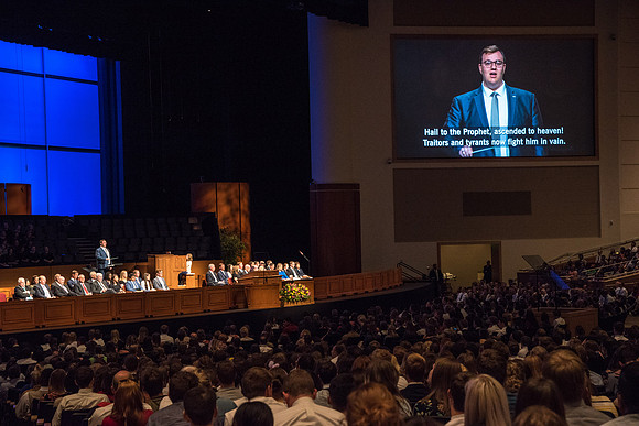 Student leads closing hymn in the I-Center.