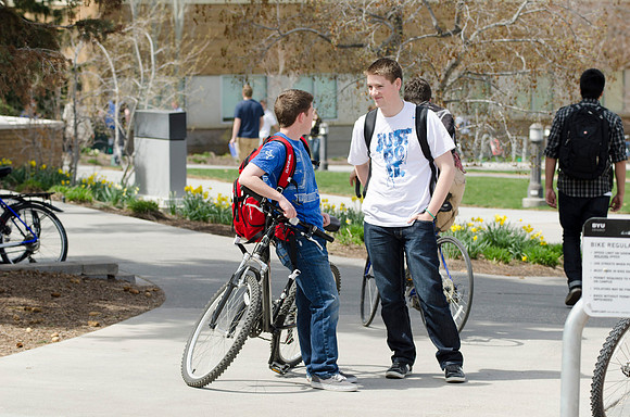 Two men converse outside the Mckay Library.