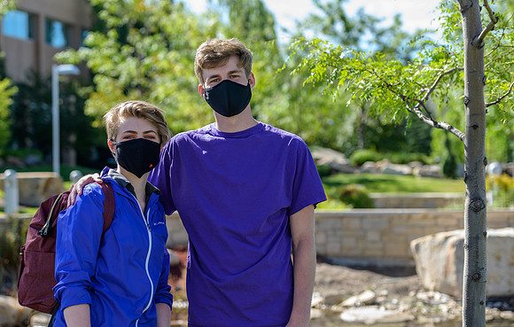 Student volunteers show the way to stay safe during this COVID 19 pandemic by social distancing, following pathway arrows and proper wearing of masks .