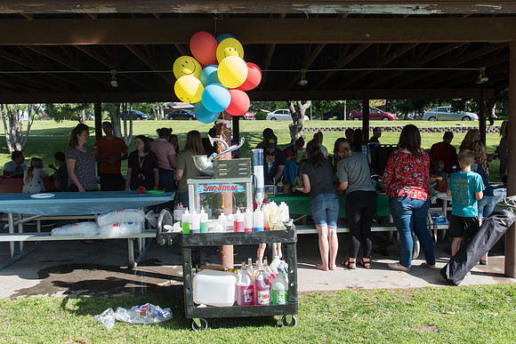 Student Living department employees and their families enjoy a picnic at Smith Park, to celebrate 10 years of being an organization.