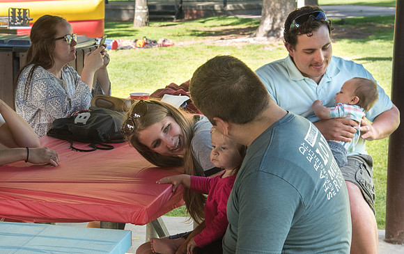 Student Living department employees and their families enjoy a picnic at Smith Park, to celebrate 10 years of being an organization.