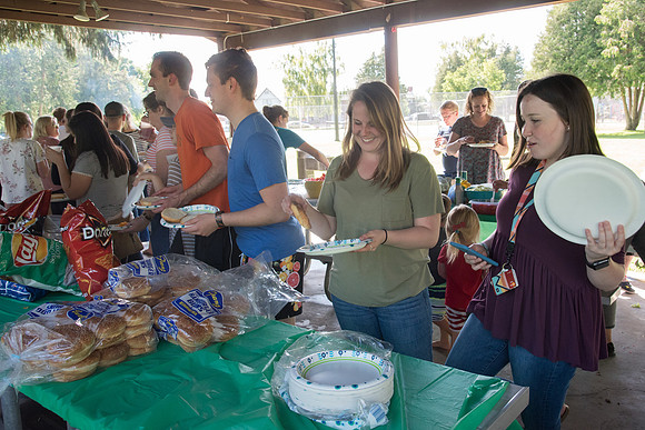 Student Living department employees and their families enjoy a picnic at Smith Park, to celebrate 10 years of being an organization.