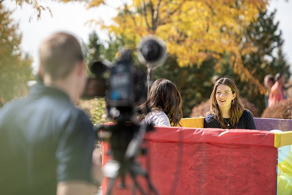 Students who volunteer to participate sit in the ball pit and ask each other questions which are found on the balloons. Video is being produced for Student Living.