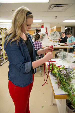 Horticulture students prepare for a semester review fashion show that will show their floral designs as well. Brother Romney leads the students along with other instructors.