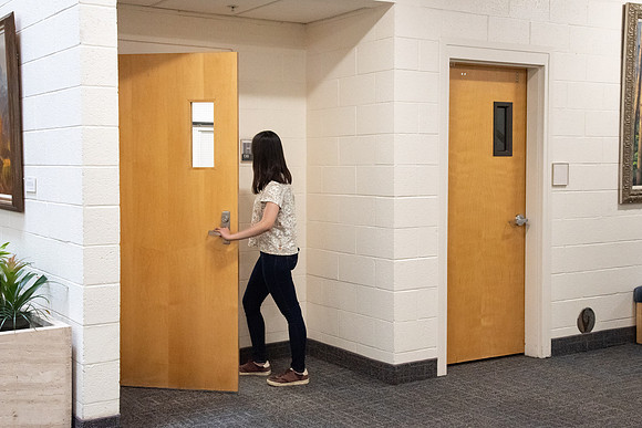 Examples of students staying safe and healthy during the COVID-19 pandemic by social distancing, following pathway arrows, and wearing face masks.