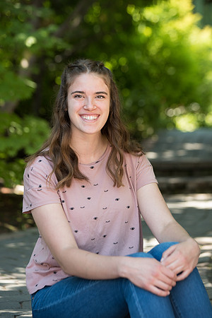 Rachel Oickle smiles for a photo in the gardens on campus and is a Financial Aid recipient.