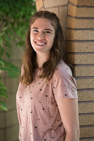 Rachel Oickle smiles for a photo in the gardens on campus and is a Financial Aid recipient.