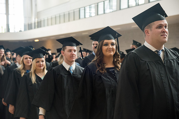 Graduates gather for procession before Commencement Services in the BYU-Idaho Center Courts.