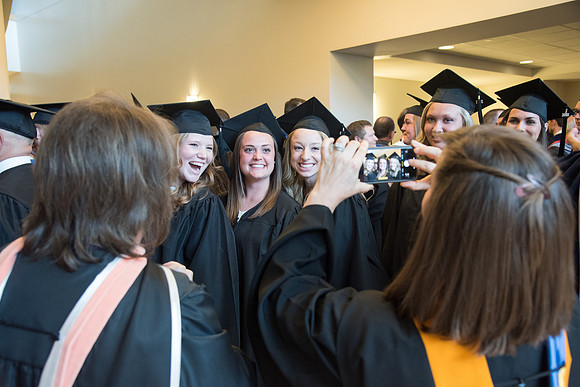 Graduates gather for procession before Commencement Services begin in the BYU-Idaho Center.