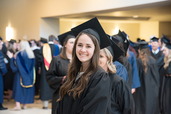 Graduates gather for procession before Commencement Services begin in the BYU-Idaho Center.