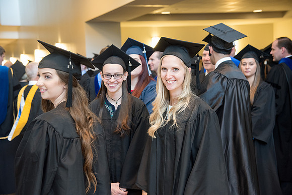 Graduates gather for procession before Commencement Services begin in the BYU-Idaho Center.