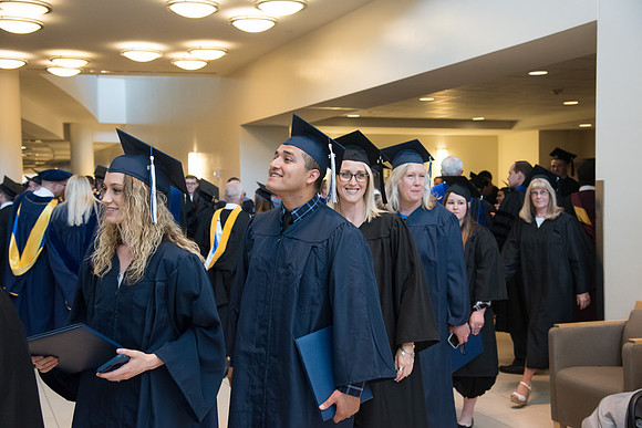 Graduates gather for procession before Commencement Services begin in the BYU-Idaho Center.