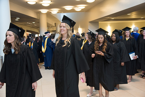 Graduates gather for procession before Commencement Services begin in the BYU-Idaho Center.