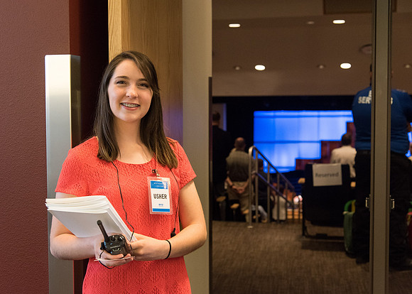 An Usher helps at Commencement Services in the BYU-Idaho Center.