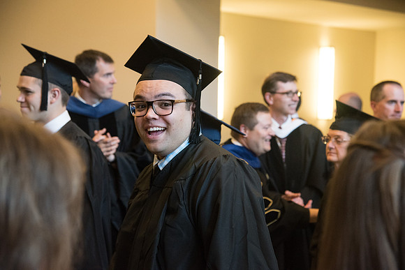 Graduates gather for procession before Commencement Services begin in the BYU-Idaho Center.