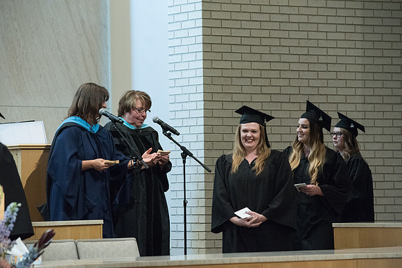 Awarding of Diplomas to graduates at the Home and Family Convocation in the Taylor Chapel.