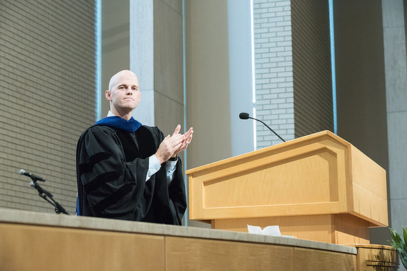Derrel J. Higgins, Department of Family Chair applauds the graduates in the Taylor Chapel.