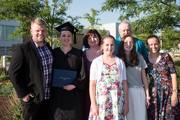 Graduate with their Family outside the Taylor Building.