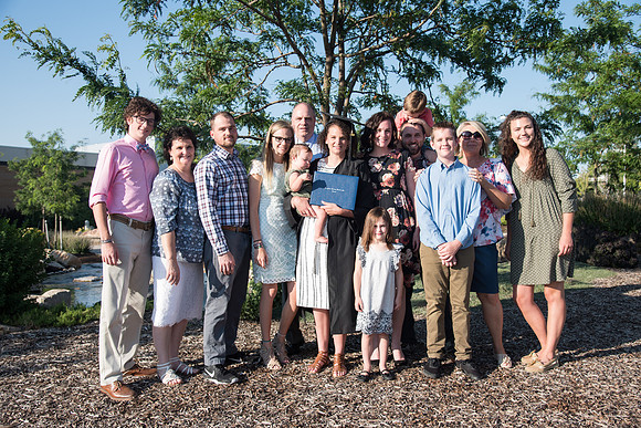Graduate with their Family outside the Taylor Building.